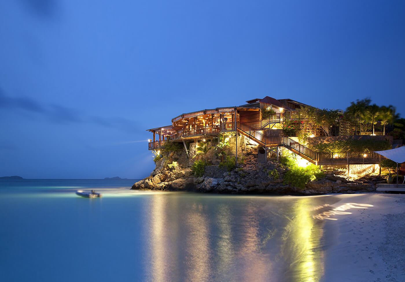 Well lit house on a mini island